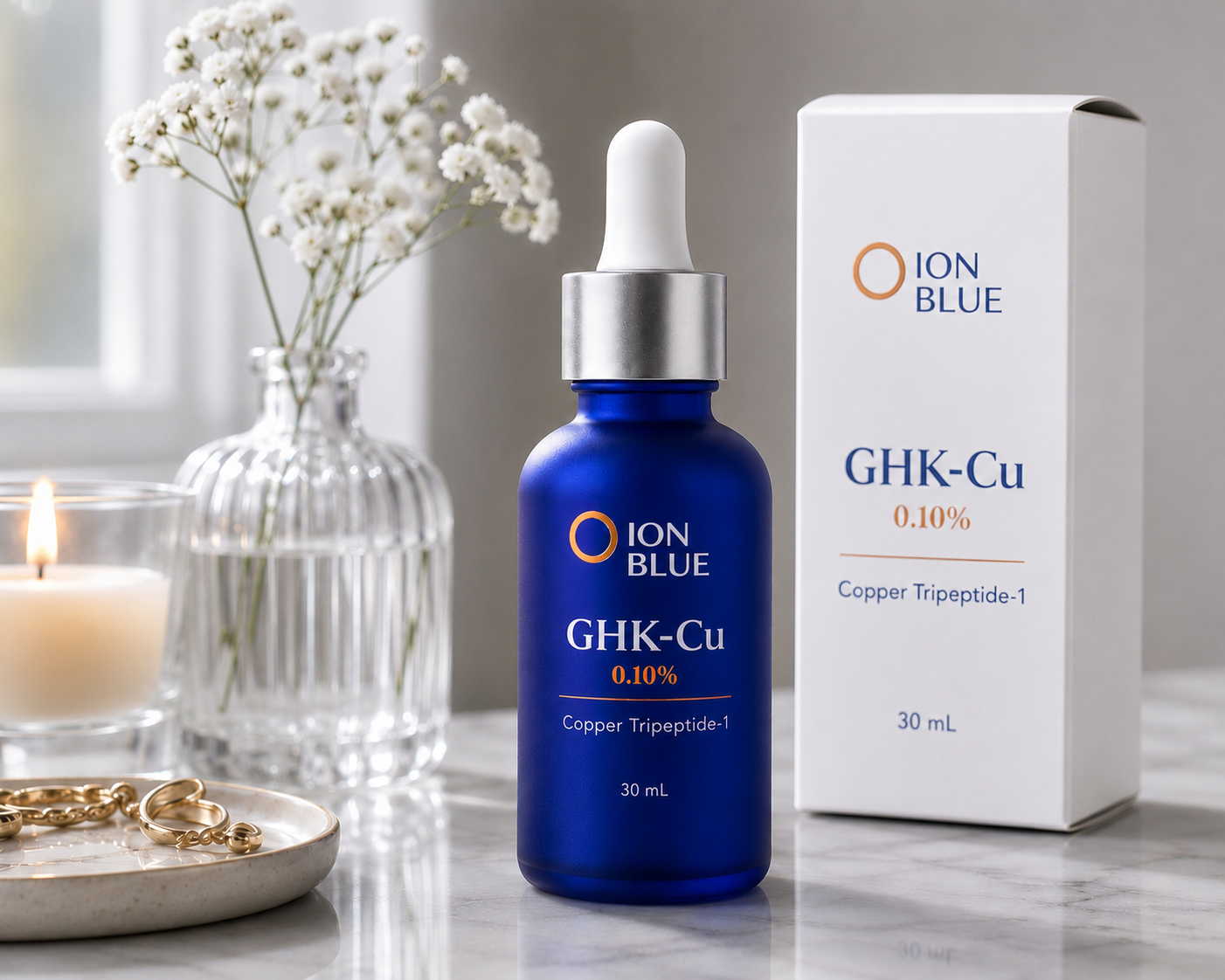 ION BLUE GHK-Cu serum bottle placed beside its product box on a marble surface.
